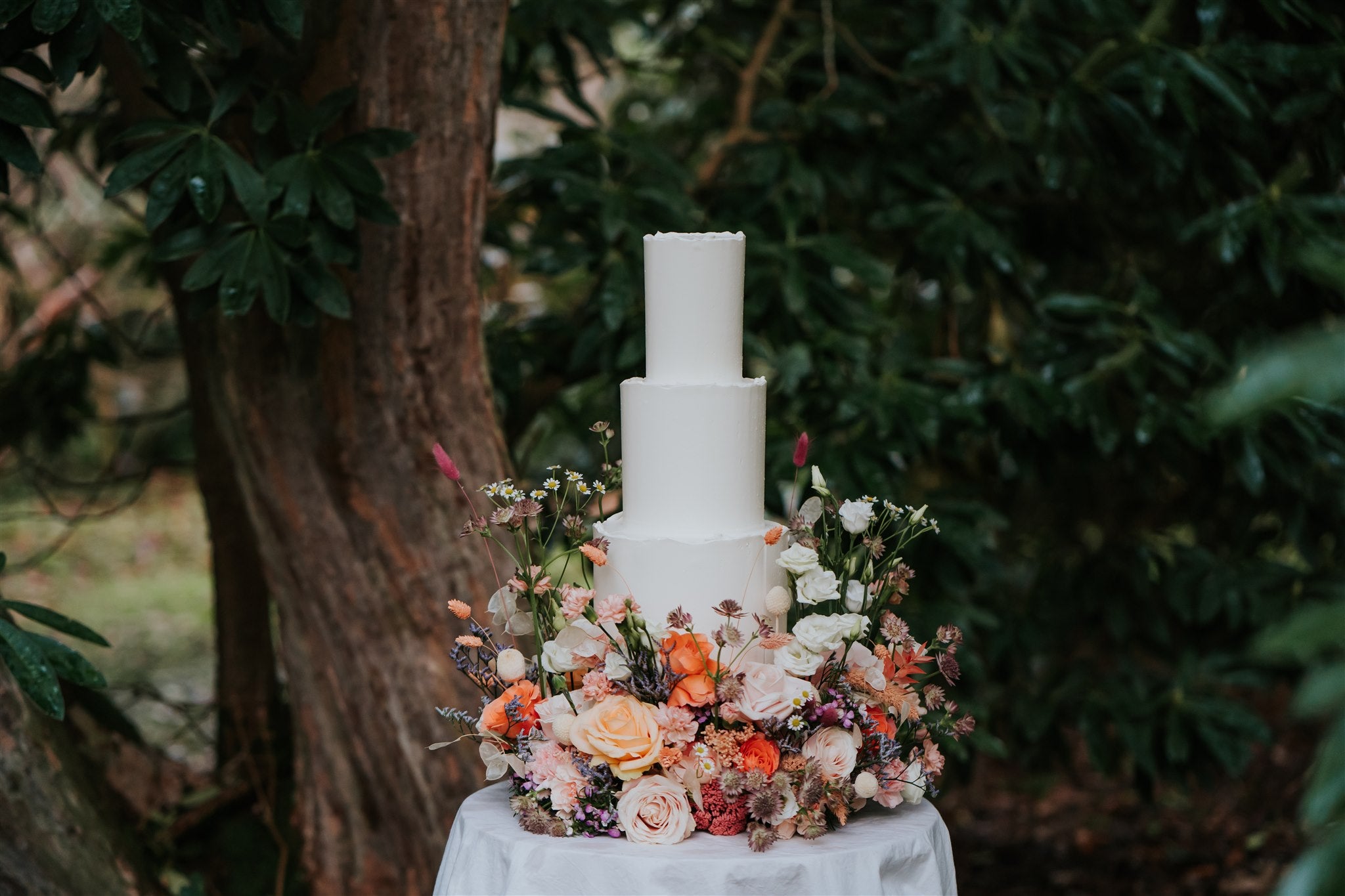 Three tier white wedding cake with flower meadow. Created by Pastel by Rachel. Wedding cakes Ireland. Wedding cakes Northern Ireland